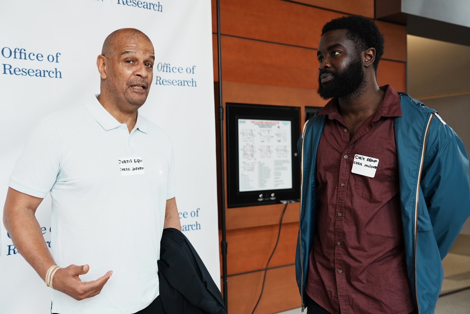 Two contractors speak during the networking period