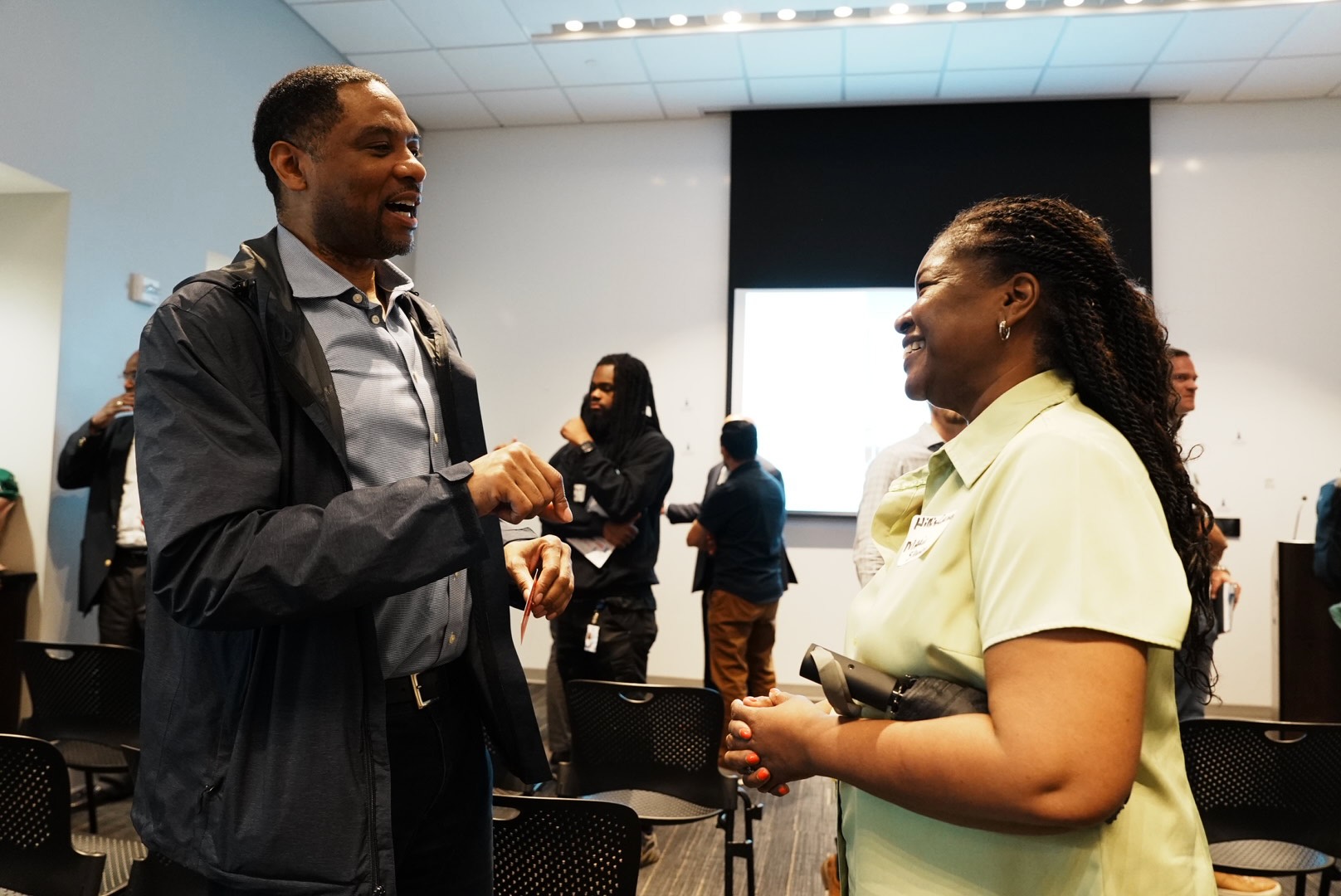 Attendees discuss the project after the presentation
