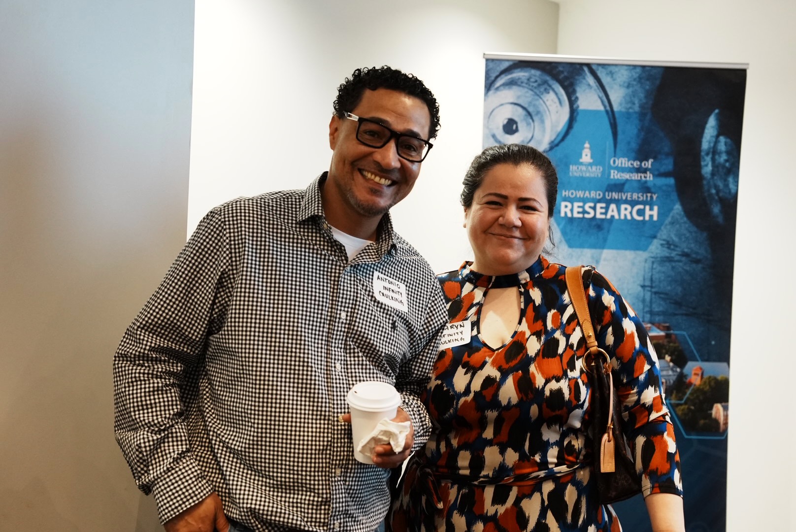 Two attendees pose during the Howard Hospital outreach event