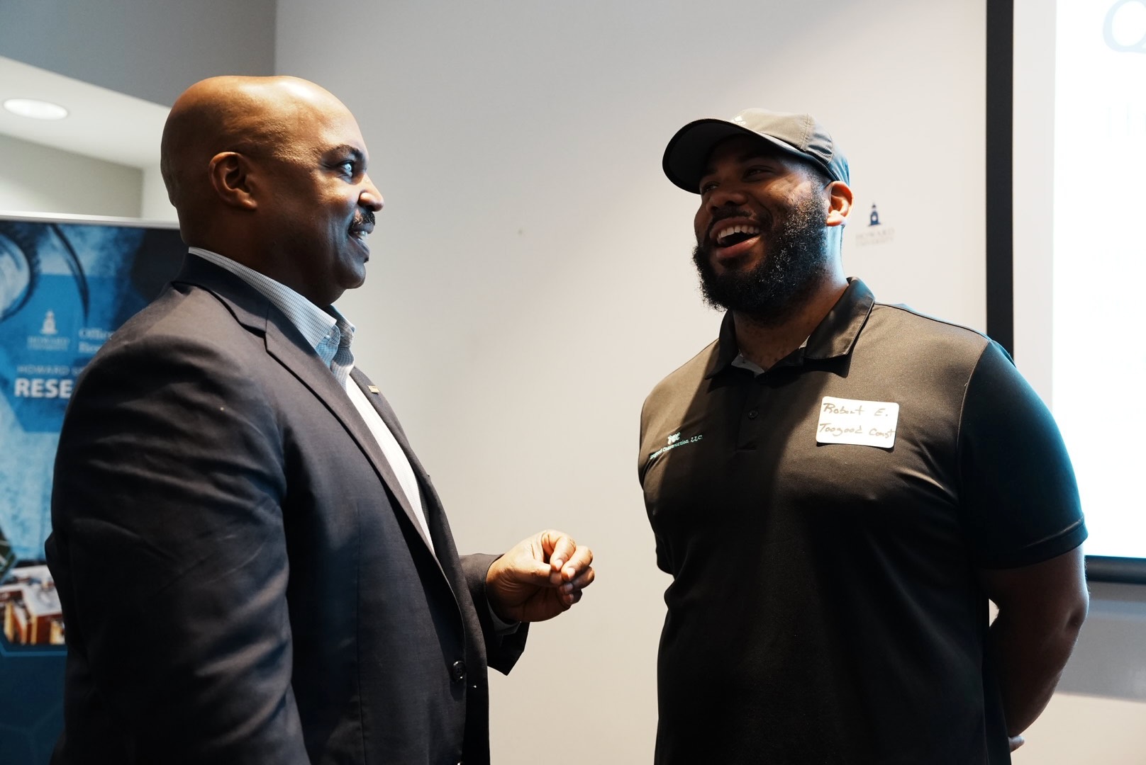 A project representative and contractor continue their conversation after the program