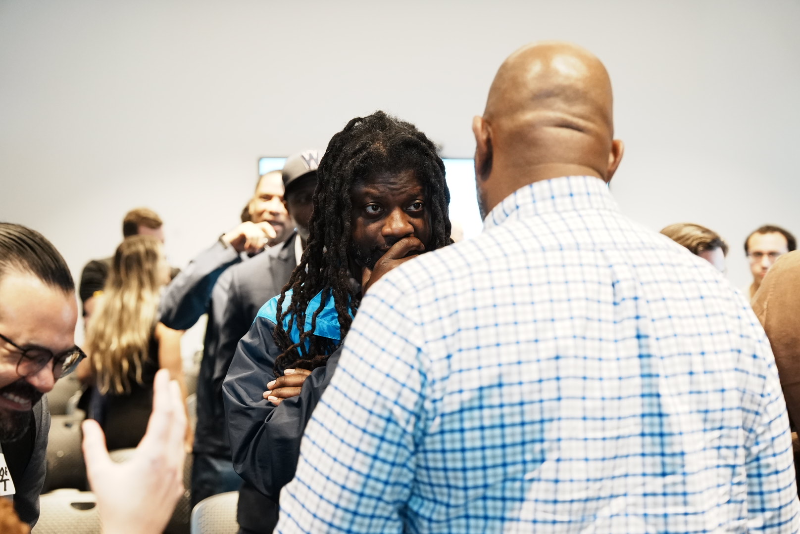 A trade professional speaks with another attendee during the outreach event