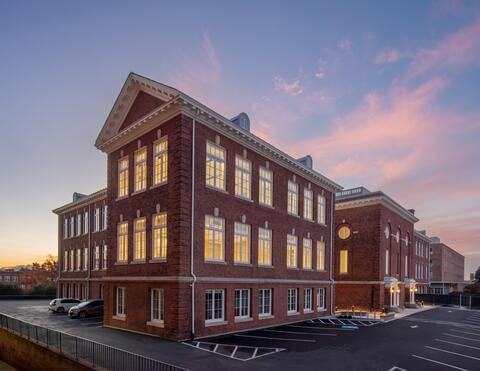 Exterior of Howard University’s renovated Miner Building at sunset